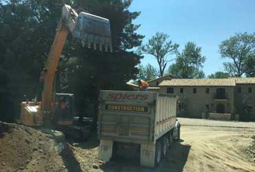 Backhoe Dump Truck Hauling Dirt